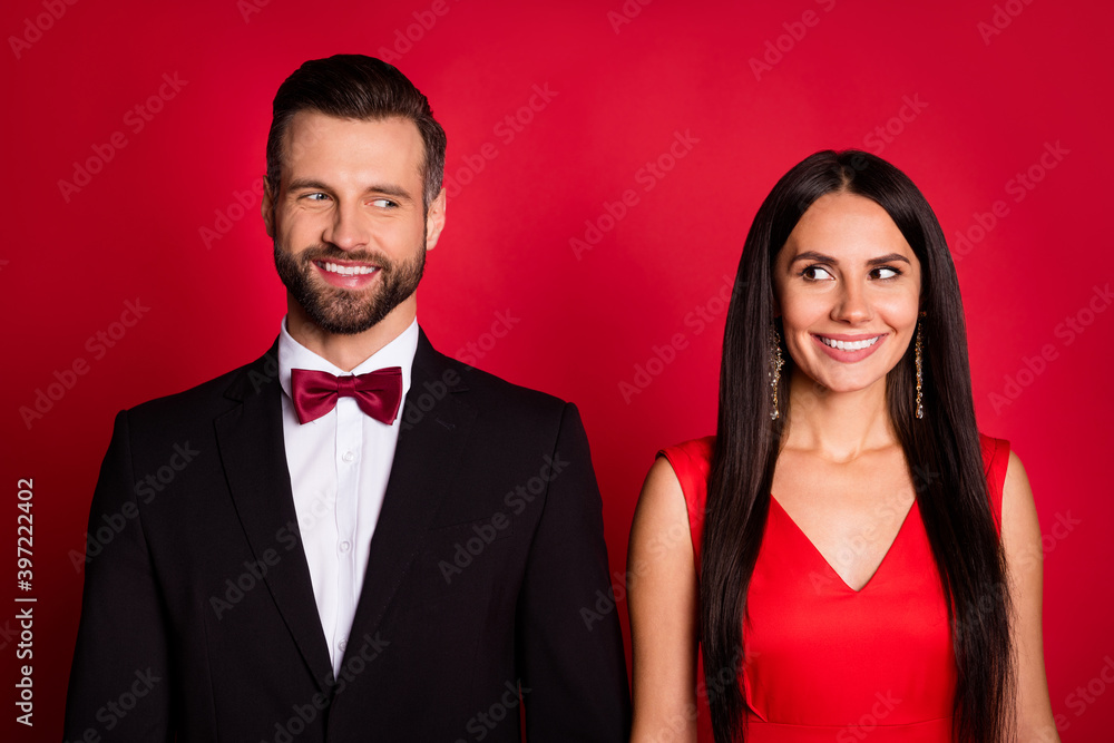 Photo of attractive lady handsome guy look each other good mood isolated on red color background Photo of attractive lady handsome guy look each other good mood isolated on red color background