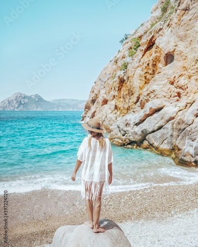 Woman at Ficajola beach in Corsica, France. 
