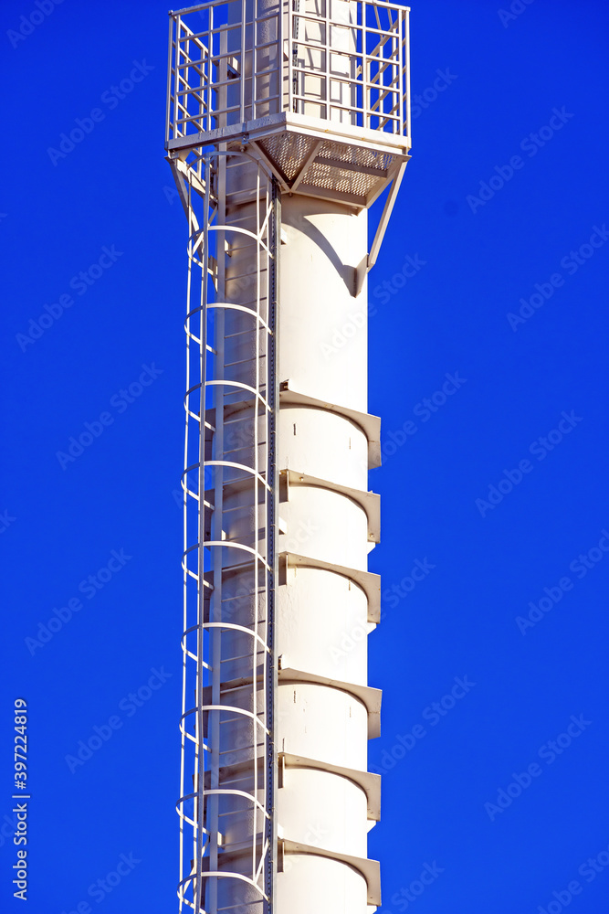 Fragment of a lighting mast against the background of a winter blue sky in Sunny weather
