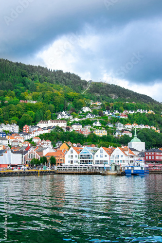 Bergen in Norway. View of historical colorful buildings in Bryggen. Colorful historic houses situated in the harbor. Mountains in the background. UNESCO World Heritage Site 