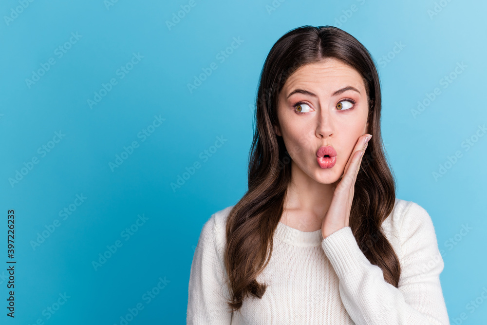 Photo of impressed charming wavy lady wear white sweater arm cheek isolated blue color background Photo of impressed charming wavy lady wear white sweater arm cheek isolated blue color background