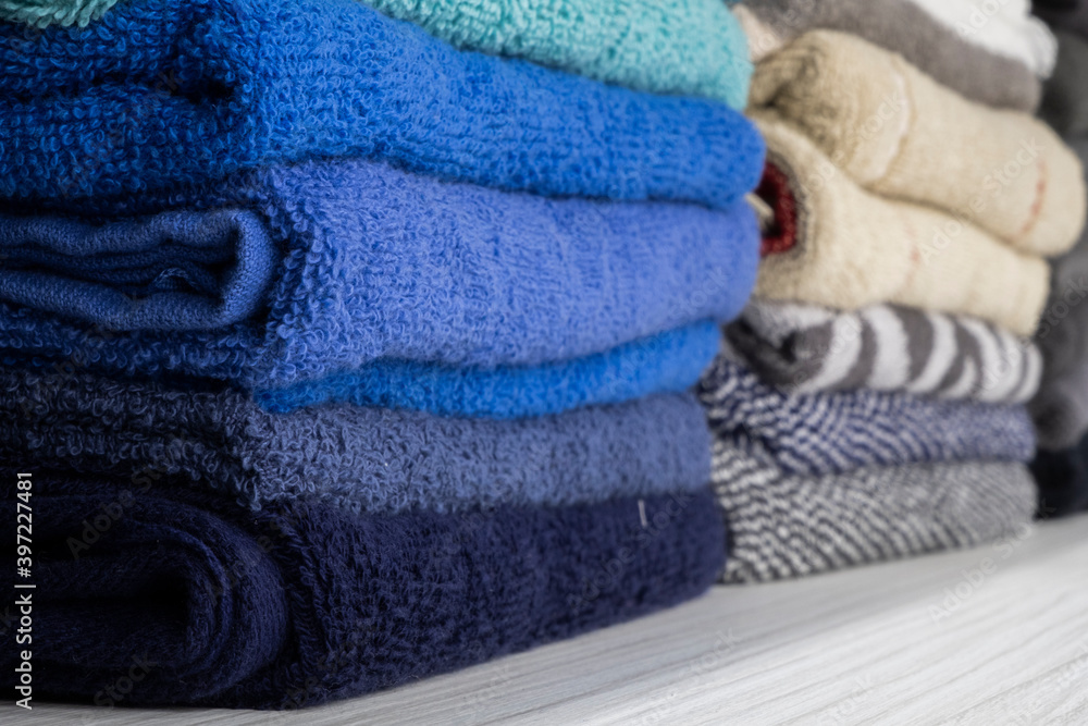 different color towels folded in the bathroom as background
different color towels folded in the bathroom as background