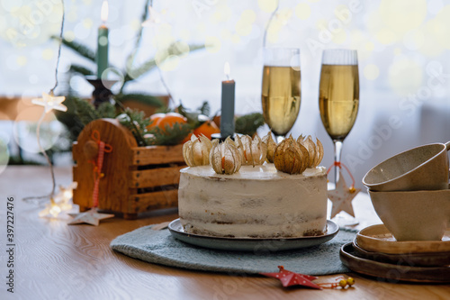 Christmas and celebration with tangerines  champagne and homemade cake. New Year holiday decorated table