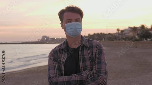 Pandemic, portrait of a young tourist man wearing protective mask walking during lockdown, empty streets. the concept health and safety, N1H1 coronavirus quarantine, virus protection