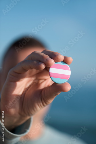 person showing a transgender pride flag