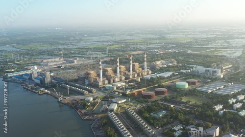 Electricity Authority Station, thermal power plant by the river, machine working to generate electricity, power station, electrical power plant. energy concept, evening sky. photo