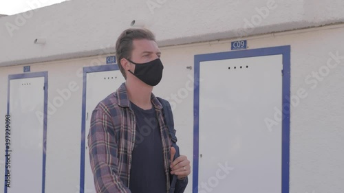 Transport Engineer Man Wearing Medical Face Mask for Prevention Coronavirus Epidemic Situation in Port Logistic Shipping Yard. Transportation and Logistics after Coronavirus Covid-19