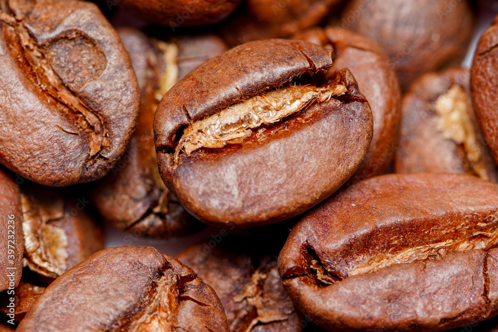 Macro view of fresh roasted Arabica coffee beans, extreme close up photo of fresh coffee beans. Macro view of fresh roasted Arabica coffee beans, extreme close up photo of fresh coffee beans.