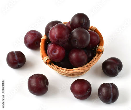 Slide of organic plums on white background