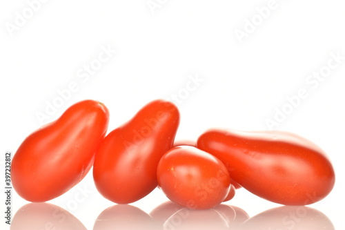 Fresh bright red tomatoes in the shape of a strawberry, close-up, isolated on white.