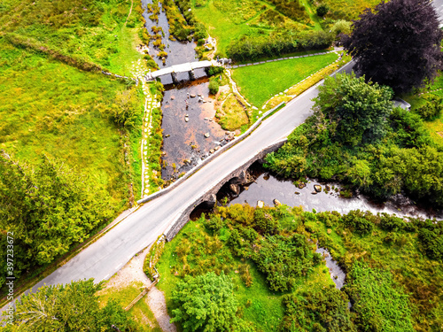 A view of Postbridge Clapper Bridge in Dartmoor National Park is a vast moorland in the county of Devon, in southwest England photo