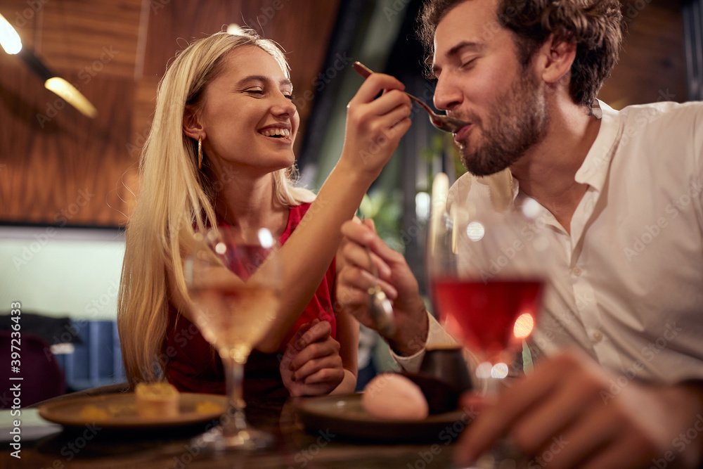A young couple in love having a good time together at Valentine's day celebration at a restaurant. Together, Valentine's day, celebration A young couple in love having a good time together at Valentine's day celebration at a restaurant. Together, Valentine's day, celebration