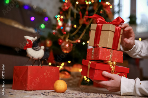 Teenage hands holding Christmas gifts.