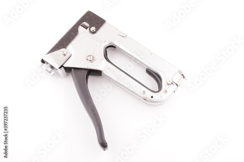 metal construction stapler on white background