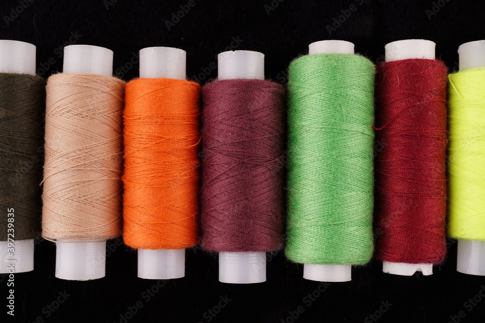 colored threads on a black background colored threads on a black background