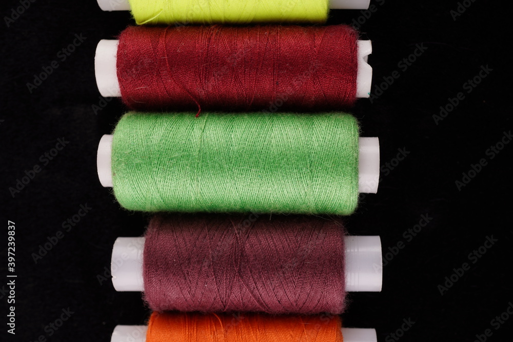 colored threads on a black background colored threads on a black background