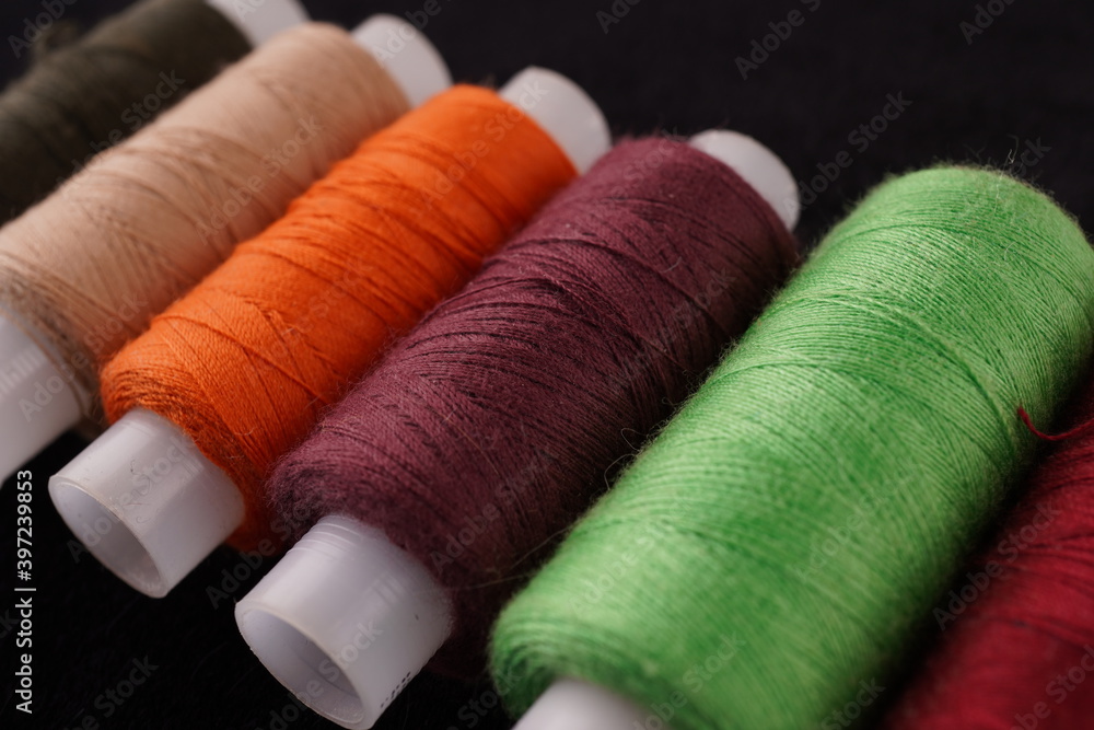 colored threads on a black background colored threads on a black background
