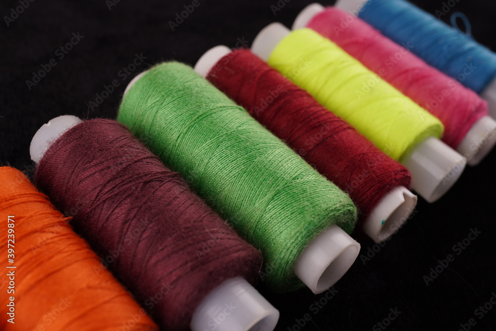 colored threads on a black background colored threads on a black background