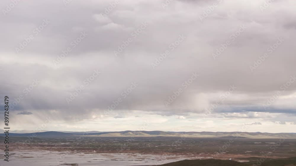 Scenic view of clouds motion over the valley with mountains in skyline. Source of Huan He (Yellow river). Tibetan highlands, Qinghai province, China. 4K UHD timelapse. Scenic view of clouds motion over the valley with mountains in skyline. Source of Huan He (Yellow river). Tibetan highlands, Qinghai province, China. 4K UHD timelapse.