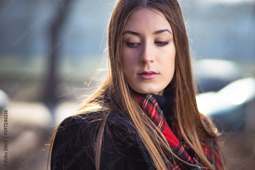 Outdoor portrait photo of cute blonde girl in black jacket and red scarf Outdoor portrait photo of cute blonde girl in black jacket and red scarf