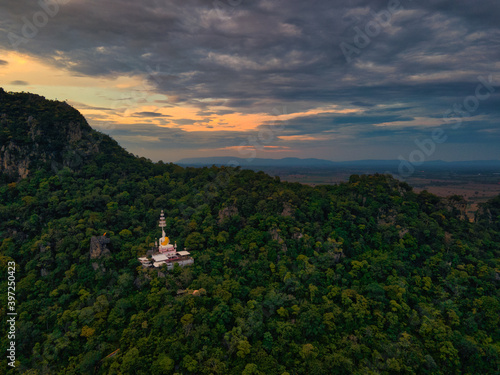 Mueang Lop Buri District  Lopburi   Thailand   October  11 2020   Wat Pa Phatthara Piyaram. Temple with cave carvings.  Aerial View of Buddha Temple Pagoda with Mountain and Blue sky
