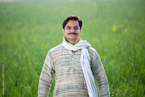 Happy Indian farmer in agricultural field outdoor