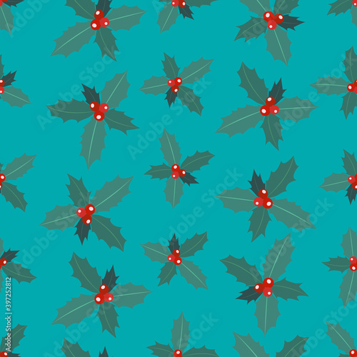 Seamless pattern of branches of Christmas holly with berries on a blue background. 