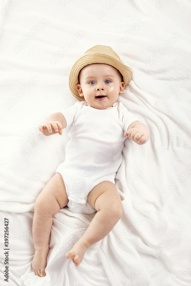 Cute baby boy smiling to the camera, lying on white background. Cute baby boy smiling to the camera, lying on white background.