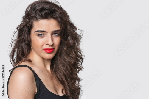 Portrait of an attractive young woman against gray background