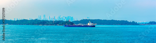Commercial shipping passing the lighthouse in the Singapore Straits in Asia in summertime