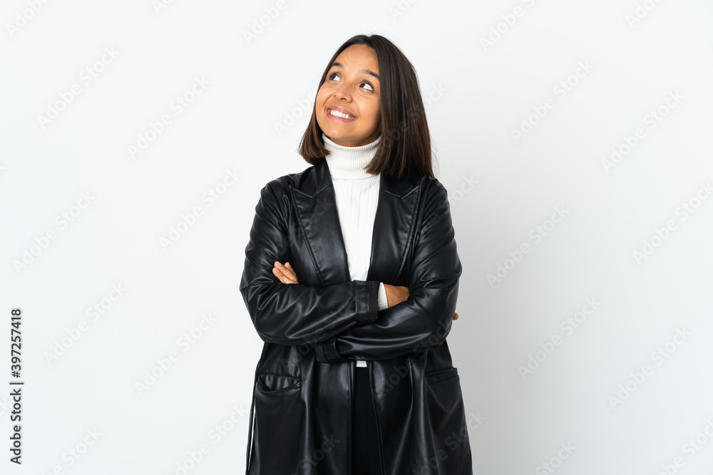 Young latin woman isolated on white background looking up while smiling Young latin woman isolated on white background looking up while smiling