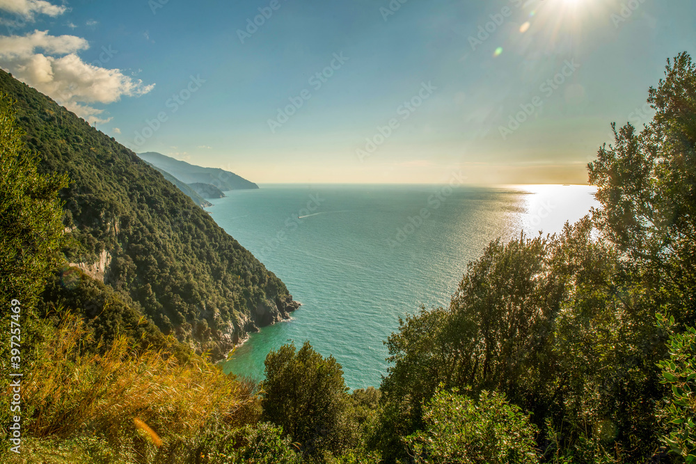 Fantastic view on Ligurian Coast from Azure Trail  -  mountains  and speed boat in water of Mediterranean Sea