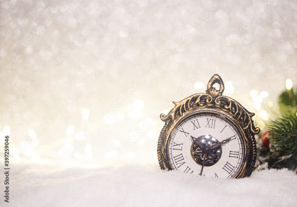 Christmas decoration with clock over snow lighting background.