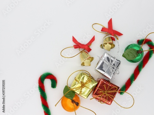 Christmas preparation elements, gift box, small bell, copy space, on a white background.

T
