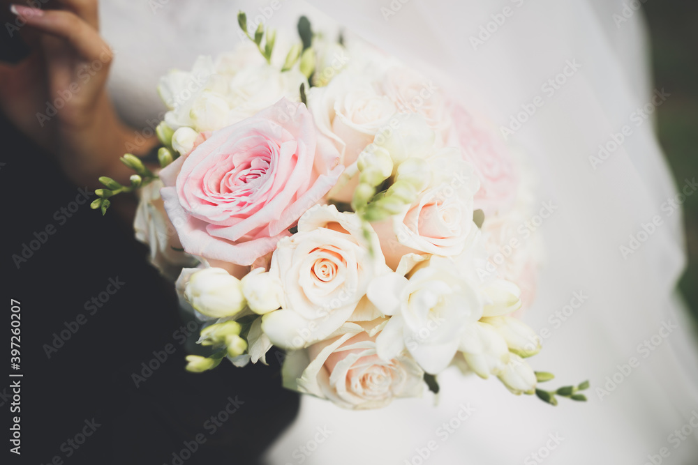Perfect wedding couple holding luxury bouquet of flowers Perfect wedding couple holding luxury bouquet of flowers