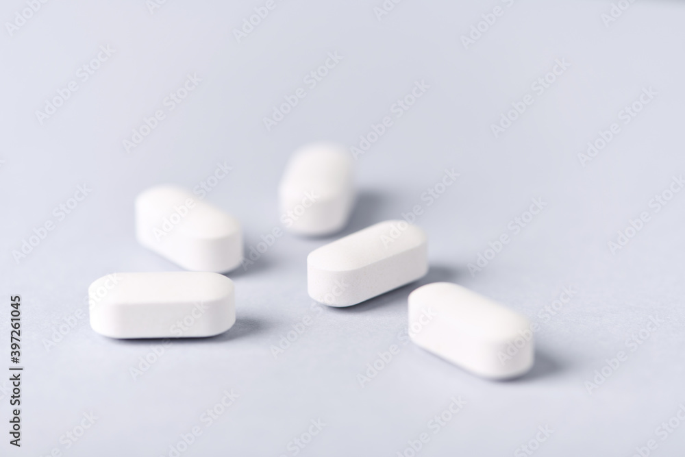 Carnitine tablets. Concept for a healthy dietary supplementation. Bright paper background. Soft focus. Close up. Carnitine tablets. Concept for a healthy dietary supplementation. Bright paper background. Soft focus. Close up.