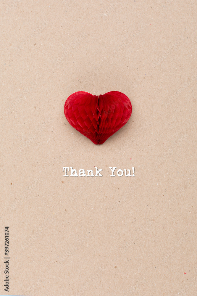 International Thank you day. Greeting card with craft red paper heart on natural beige background. Flat lay, top view. International Thank you day. Greeting card with craft red paper heart on natural beige background. Flat lay, top view.