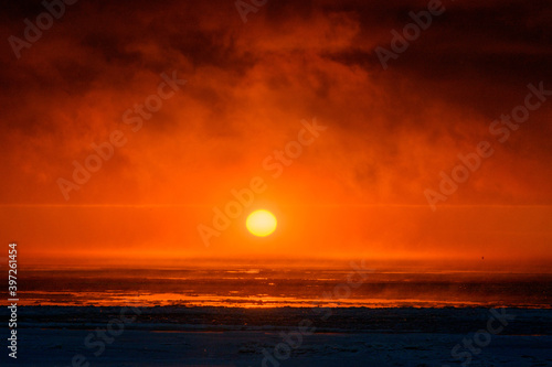 Beautiful sunset with fog in Arctic sea. © Alexey Seafarer