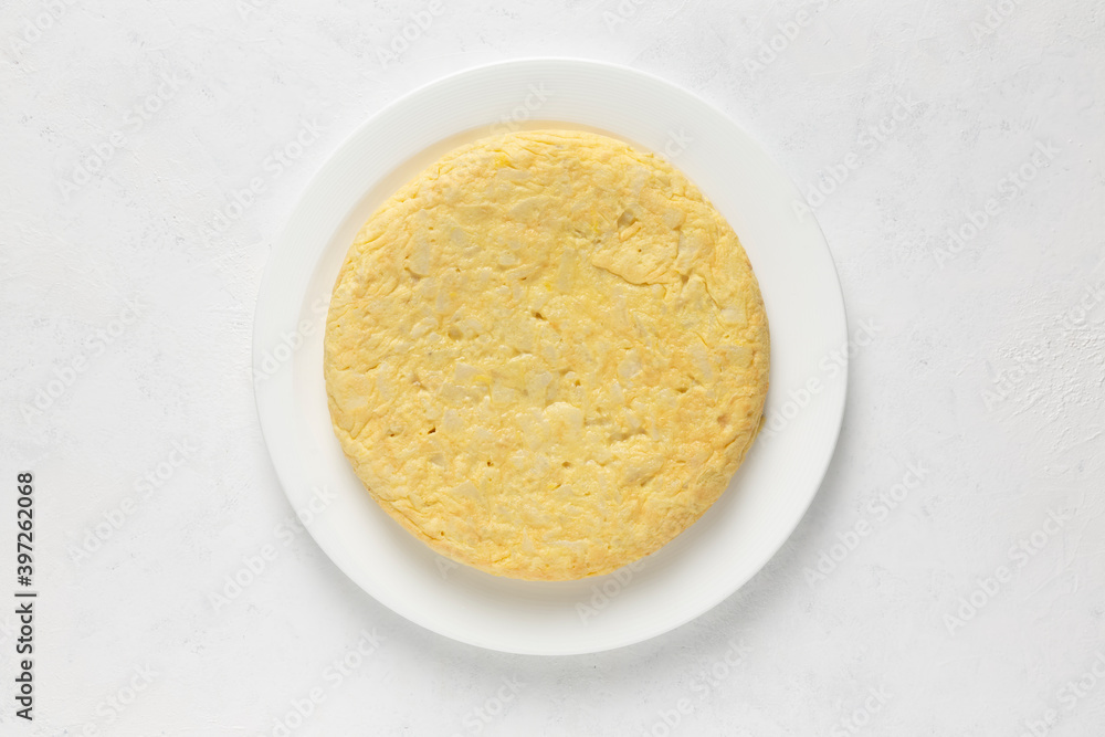 Spanish omelette in a round white plate on white background. Senital view. Horizontal image Spanish omelette in a round white plate on white background. Senital view. Horizontal image