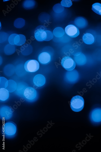 Abstract pattern of blue bokeh lights on black background