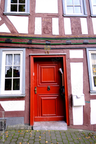 old wooden door entrance to the house, concept of the beginning of a new life, magic portal, medieval European architecture, history of cities