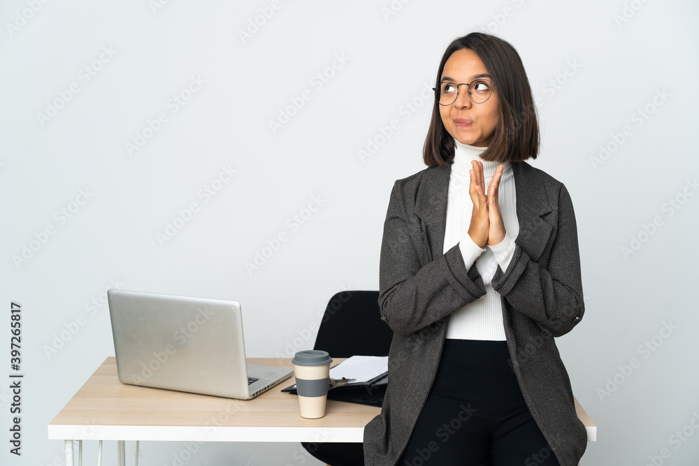Young latin business woman working in a office isolated on white background scheming something Young latin business woman working in a office isolated on white background scheming something