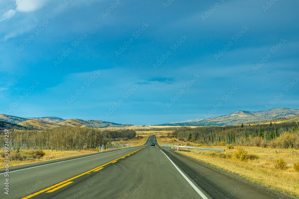 Country road, rural landscape in autumn season. Alberta Provincial Highway No. 22, also known as the Cowboy Trail. Alberta, Canada. Country road, rural landscape in autumn season. Alberta Provincial Highway No. 22, also known as the Cowboy Trail. Alberta, Canada.