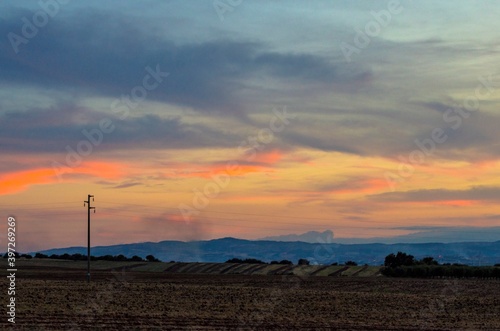 High voltage pylon in the countryside at sunset