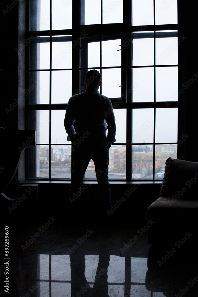 Man looking out the window. Businessman. Industrial. From window Man looking out the window. Businessman. Industrial. From window