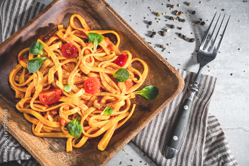 Pasta with tomato sauce and basil. Delicious tagliatelle. Italian tasty food