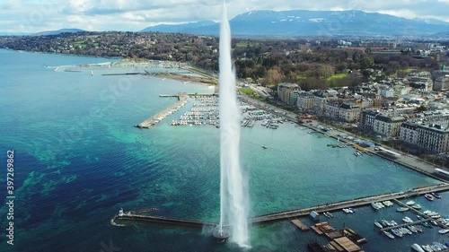 Aerial view of Geneva and aerial view of water jet fountain. Drone flying over the picturesque cityscape 