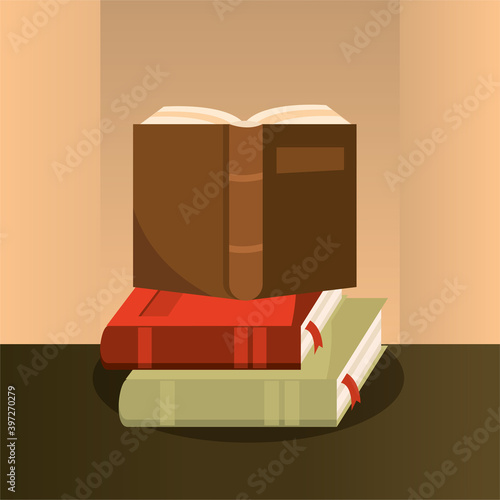 open book on stack of textbooks reading design