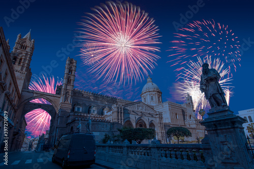 Celebratory fireworks for new year over Palermo Cathedral in Palermo, Italy during last night of year. Christmas blue atmosphere 