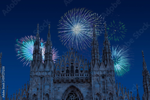 Celebratory fireworks for new year over Milan cathedral or duomo di milano during last night of year. Christmas atmosphere